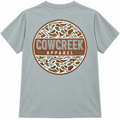 Back of Bay blue-green T-shirt with a large circular Cow Creek Apparel logo in brown, green, and cream camouflage.
